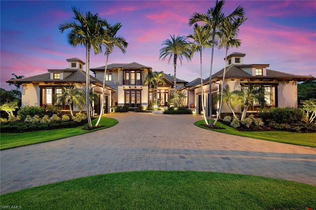 Designer luxury lakefront estate offers a blend of tranquility, sophistication, views and exceptional quality throughout. Best of all, the home was built above the current FEMA level, and home, garages, cabana and pool are high and dry and have never been close to flooding from any hurricane. The FEMA flood insurance policy is under $1,000. Designed by architect John Cooney, the 7,660-square-foot residence is an architectural masterpiece, featuring a harmonious mix of warm tones and a refined minimalist aesthetic. From the moment you walk through the entrance, there is a sense of subtle elegance and meticulous craftsmanship that defines every aspect of this exceptional property. The gourmet kitchen is outfitted with luxury appliances, dual islands with new quartz countertops, walnut cabinetry and an adjacent dining area. The adjoining living area complements this space with a gas fireplace, while a dedicated wine area boasts double beverage refrigerators and wet bar, ideal for entertaining. An adjacent theater room provides a private cinema experience. The primary suite is complete with a tranquil sitting area, a spa-like bath featuring premium finishes, and an attached fitness room for convenient at-home workouts. Step outside onto the expansive covered lanai, where indoor and outdoor living blend seamlessly with a gas fireplace, ample space for lounging and dining, and breathtaking panoramic views of the sparkling lake. The outdoor oasis extends to a separate guest cabana, overlooking the magnificent infinity pool. Multiple seating areas highlight the views of the surrounding lake, while lush landscaping adds a sense of privacy. Three blocks from the pristine sandy beaches and a short distance from the renowned shops and restaurants of Fifth Avenue South, this exquisite estate provides a serene escape in one of Naples most desirable neighborhoods, amid luxurious residences and meticulously maintained tropical landscapes.