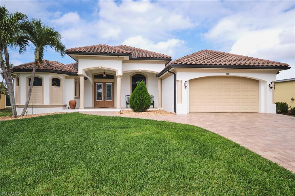 !!! THE SELLER IS MOTIVATED TO SELL !!! This is a DREAM HOME in one of the most sought-after locations, featuring a total built area of 3,620 square feet, constructed with luxury features, superior quality, and meticulous attention to detail. The home boasts 14-foot ceilings, foam insulation, 3 bedrooms plus a dedicated study, 2 bathrooms finished entirely in travertine, and an oversized garage with space for more than two cars and a separate tool room. This beautiful residence features upgraded cherry wood cabinetry with granite countertops, a high-end appliance package, and a spacious living area. Travertine flooring extends throughout the entire home, including the outdoor living spaces. The interior is adorned with crown molding and custom millwork throughout; the master suite includes a walk-in shower with direct access and a jetted soaking tub. Outdoor amenities include a large, heated Jacuzzi with a saltwater system, an oversized lanai, and a full outdoor kitchen. Additional features include a tile roof, an expansive paver driveway, and pocket sliding glass doors that recede completely into the walls to seamlessly blend indoor and outdoor living spaces. The home is equipped with impact-resistant windows and sliding doors; the pool enclosure screen was installed in 2026, and the air conditioning system was installed in 2022. The sale includes all home furnishings—valued at over $50,000—and the adjacent rear lot is also available for purchase, offering an excellent opportunity to expand your property and make your estate even more expansive. All municipal water and sewer assessments have been paid in full. Conveniently located near the Cape Harbour Marina, as well as local restaurants and shops!