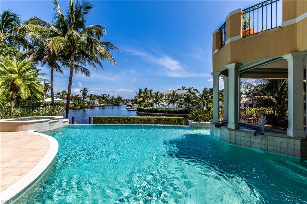 After a total price reduction of $800,000, this is the BEST PRICED move-in ready Gulf access home with open water views in Aqualane or Port Royal.  

Located on one of the premier lots in the exclusive community of Aqualane Shores, this classic estate home provides captivating, expansive water views with a two-story wall of glass overlooking the pool and waterway to the Gulf of Mexico. The home is immaculate and has all the space you need for entertaining family and guests with four en-suite bedrooms including a first-floor master overlooking the pool, den, seven bathrooms, over 5,800 square feet of interior living space and over 3,300 square feet of outdoor terrace and lanai. The open floor plan and luxurious details perfectly accentuate the water views throughout the home. Features include custom crown molding and ceiling details, marble and bamboo floors, fireplace, wine room, vanishing-edge pool, outdoor kitchen, three-bay garage, brick herringbone driveway, lush landscaping and much more. An 83 ft boat dock provides quick access to the sparkling waters of the Gulf of Mexico. The stunning white powder sand beach of Naples is just at the end of the street.