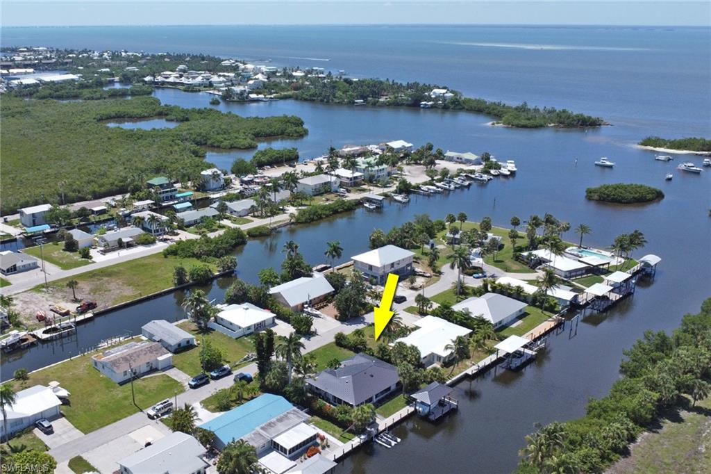 WHERE COASTAL RESILIENCE AND LUXURY DESIGN CONVERGE

Direct Gulf-access waterfront residence comprehensively rebuilt and completed in May 2026. Located just moments from Charlotte Harbor and open water, this exceptional property combines luxury finishes, modern smart-home technology, and extensive coastal engineering upgrades designed for long-term performance and ownership confidence.

The waterfront features a 90-foot seawall, full-length dock, 12,000-pound boat lift accommodating vessels up to 30 feet, double jet ski dock, and recent dock and lift upgrades including new motors, cabling, and cradle systems.The Dock offers electric, water, and custom lighting creating a seamless waterfront lifestyle. The outdoor space includes a Hotspring Envoy hot tub. The 5 seat luxury spa with advanced filtration and salt water system. 

Engineered for the Florida coastal environment, the home features Coastal Max roofing systems on both the residence and boat-lift cover, PGT impact-rated windows and doors, a hurricane-rated insulated garage door, new Rheem HVAC system, new ductwork, R-38 insulation, new plumbing, electrical, and water systems, a whole-home Kind water treatment system with triple-stage filtration and UV purification, and transferable lifetime warranties on both the roof and windows.

Inside, premium custom millwork and solid-core doors complement new waterproof and scratch-resistant luxury vinyl plank flooring throughout. The designer kitchen features Samsung Bespoke appliances, custom soft-close cabinetry with pull-outs, and abundant storage with dual pantries, including a walk-in pantry. The home also offers floor-to-ceiling tiled baths with Bernhardt vanities, California Closets throughout, a separate laundry room, and an 80-inch fireplace creating a refined yet comfortable living environment.

The Florida room was thoughtfully designed for coastal living with reinforced construction, floor-to-ceiling porcelain tile, premium waterproofing systems, and SeaDek marine flooring. In the attached garage A dedicated mini-split system creates additional climate-controlled space ideal for hobbies, storage, fitness equipment, or workshop use.

Additional features include a 3-zone Sonos audio system, Alarm.com security system, Ubiquiti UniFi AI-powered surveillance system with seven cameras and remote monitoring, professionally designed landscaping with multi-zone irrigation, and aluminum fencing with puppy panels.

A rare turnkey waterfront residence where virtually every major structural, mechanical, and waterfront component has been upgraded or replaced and engineered for the Florida coastal environment. Priced firm to reflect the superior quality of the rebuild, with verified independent bank appraisal, and significant post-appraisal luxury upgrades. This property is turnkey and priced to move.