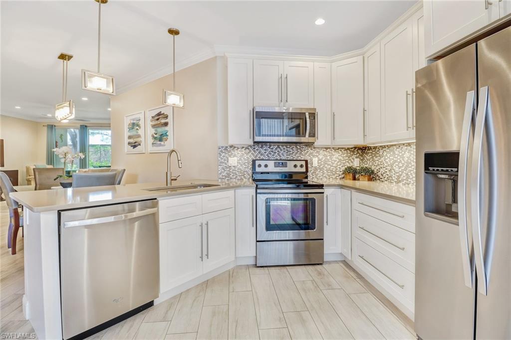 Nestled in the heart of North Naples, this first floor condo was completely renovated in 2017 with designer finishes and a coastal contemporary flair.  The beautiful re-imagined kitchen features an expanded open concept island, 42’ white shaker slow-close cabinetry, quartz countertops and custom pantry wall. Porcelain designer plank tile is installed on the diagonal throughout. Both bathrooms have undergone extensive upgrades including new vanities, quartz countertops, modern sink/faucet combos and shower surrounds. The master bathroom features a smart re-design with large frameless glass shower, dual sinks, make-up vanity and bonus linen closet. The split bedroom plan is ideal for guests and features a pocket door to block off the entire guest wing. All new whirlpool appliances in 2017 including washer and dryer pair. Located in the premium building with private location bordering Tiburon golf club with landscaped view and privacy wall. Wilshire lakes features a 24/7 guard gated entrance, community pool, tennis courts, and walking paths and is centrally located in North Naples near top rated schools, a quick ride to Mercato, grocery/convenience stores and 7 miles to the beach.