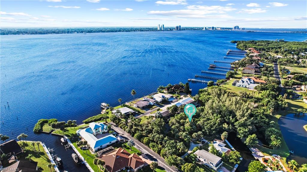 Over a Half-Acre on the Water - Intersecting Canals - Direct Access in minutes! Water on multiple sides makes you feel like you are on your own Private Island! Build your dream home on this peninsula shaped property and see why you can have plenty of waterfront for Boats and Jet Ski's while still having a water view! Quick Open Water Access with the protection of the canal. The sale includes two buildable lots being sold as one property.  335 feet on the water is perfect for multiple boats, property backs up to a lot of natural mangroves for privacy and less than 50 feet from the river for fast open water access. Affordable building site in an established waterfront neighborhood, taxes are lower in North Fort Myers than they are in Fort Myers and Cape Coral for waterfront property. Want a seawall with less wait? Owners have deposit and contract down on tree clearing and seawall. Buyer can assume the seawall contract (saves time & money) or cancel. Buyer's choice!