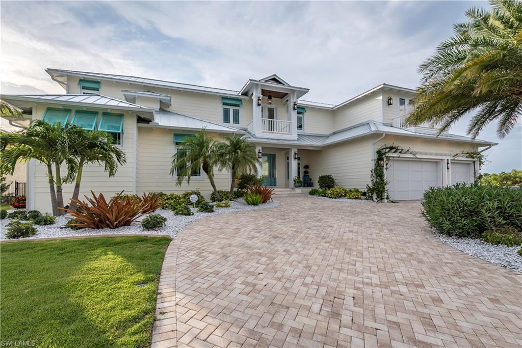 Luxury abounds in this 2017 custom pool home, FAST ACCESS water with NO BRIDGES to Charlotte Harbor and the Gulf of Mexico! Outside, a large circular driveway, upgraded landscaping, find attention to detail in every single room. The spacious foyer with large glass viewing area, frames the view of the custom pool. To the right on the main level, the dining room has a dry bar & wine fridge, built-in espresso machine, & extra cabinetry. Opening to the kitchen & great room, find custom wood working, quartz countertops, tongue & groove ceilings, windows everywhere with incredible views. Off the kitchen, a large pantry & laundry room. On the opposite side of this floor, find an office with glass French doors, a full bathroom with pool access. Upstairs, find a specialized media room with projector/screen & ambient lighting with a 1/2 bath nearby. A large landing with separate porch, one guest suite with en-suite bathroom, private porch, & 2 additional bedrooms that share a guest bathroom. By the pool, find entertaining a breeze with pocketing sliding doors, covered lanai with kitchen area, a gorgeous pool and hot tub. This home has it all! Schedule your showing today!