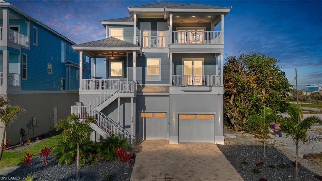 Experience the epitome of coastal luxury on Fort Myers Beach. Completed in August 2020 on the prestigious North End just steps from the beach, this TURNKEY residence offers 5 bedrooms, 5 full baths, your own private elevator and an array of upscale features designed for both comfort and entertaining. Inside, an expansive layout awaits, with two inviting living rooms, an open concept kitchen and great room floor plan complemented by a separate formal dining area, and a massive breakfast bar island. The gourmet kitchen is a chef’s dream, featuring a gas range, double wall oven, and a walk-in pantry. The residence also features two primary suites, one on each level, each with spa-inspired baths, one offering a standalone soaking tub and shower, and the other boasting a spacious double-head walk-in shower. Recent enhancements elevate the home's appeal, including a full home audio/visual system that enriches the ambiance, power shades in living area and primary bedroom, and tasteful shiplap accents throughout the living spaces that evoke a refined, luxury coastal feel. Outdoor living shines with multiple balconies that capture breathtaking views, enjoy sunrises over Estero Bay and unwind with spectacular sunsets over the sparkling Gulf waters. A downstairs game room opens directly to a saltwater heated pool overlooking the canal with floating jet ski docks and ample room for a boat. Ideal for both personal retreats and savvy investments, weekly rentals are allowed. This retreat invites you to embrace a lifestyle of unparalleled luxury, convenience, and coastal elegance, a residence you simply cannot miss.
