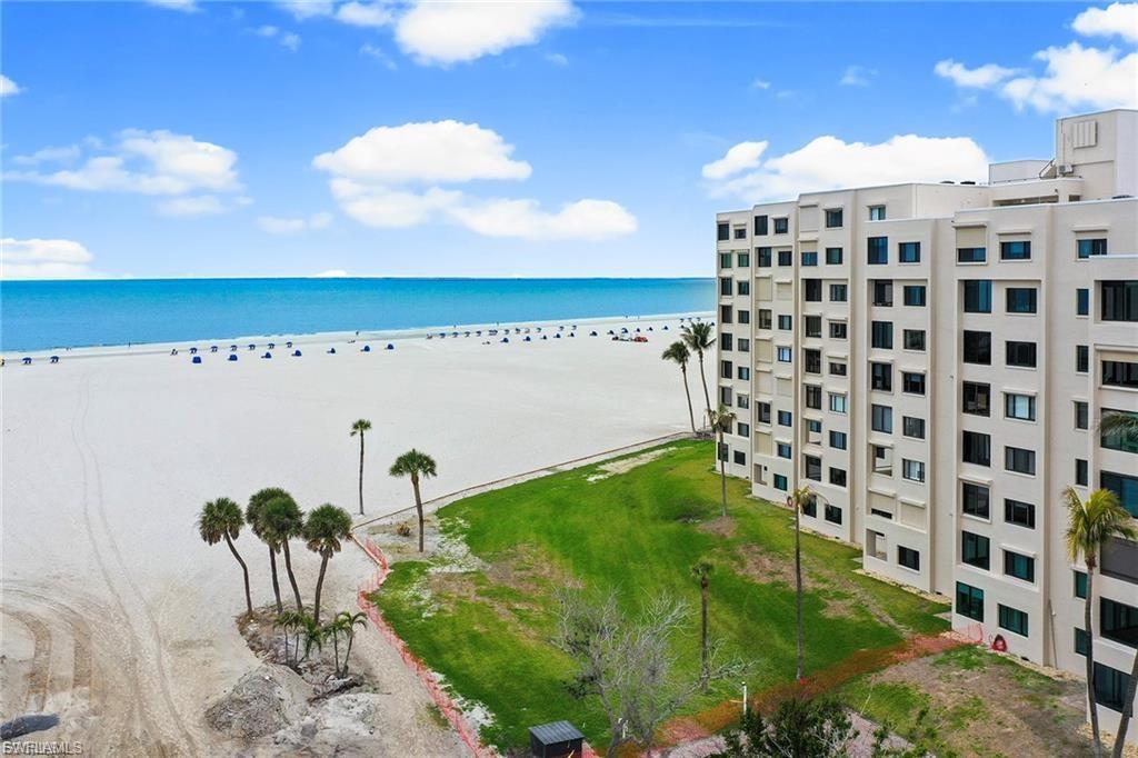 Enjoy beachfront living in this beautifully remodeled 2-bedroom, 2-bathroom condo on Fort Myers Beach. The entry to this condo is unique and versatile allowing for ample storage, a sitting area or even an office. This stunning open-concept home features a modern kitchen with trey ceilings, granite countertops and stainless steel appliances, perfect for entertaining. The split floor plan offers privacy and comfort, with a spacious guest room and a guest bath complete with a tub and shower combo. The master suite boasts tray ceilings, sliding doors for added privacy, and an ensuite bath with a walk-in shower. The living room has coffered ceiling design with added lighting along abundant natural light fills the space, showcasing breathtaking views of the beach and the Gulf of Mexico. Hurricane windows throughout provide added peace of mind. Don't miss the opportunity to own this beachfront gem with spectacular views and stylish updates! This unit also has a brand new air conditioner which was installed March 2024.