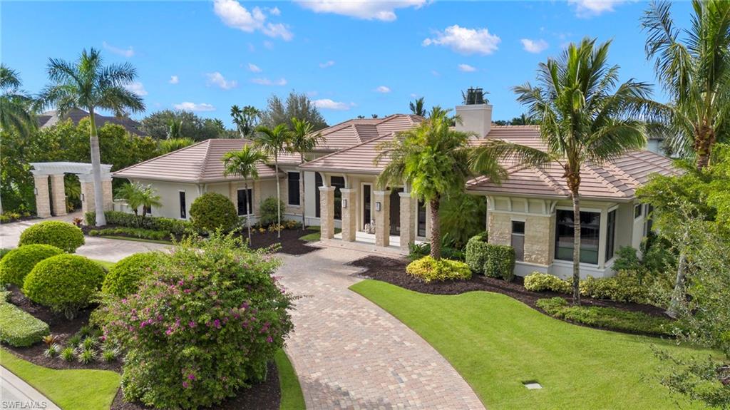 The visually stunning former Adderley model by McGarvey Custom Homes features 6,128 square feet of wondrous living space. Nestled in the Naples golf community of Quail West, this home provides the quintessential luxury indoor/outdoor living experience. Superbly designed layout showcasing multiple entertaining areas and views of the many water features, pool and Lakes Golf Course. Natural light fills the home via floor-to-ceiling windows and sliding glass pocket doors. Beautiful custom-designed asymmetrical fireplace. Unique floating ceilings with ambient cove lighting creates visual separation between the open living spaces. Formal dining room sized for lavish entertaining, a spectacular U-shaped bar, and glass enclosed walk-in wine room. 4 spacious bedrooms, 4 baths, 2 half baths, massive double-island kitchen, den/office, three-car air-conditioned garage plus a separate dedicated golf cart garage. Enormous outdoor living includes kitchen, bar, dining, and TV area with two-sided fireplace. Multi-tiered water features, floating walkway to the custom pool, edgeless spa and chaise shelf. Sunken seating area with fire pit. Complete with screens and hurricane shutters. Welcome home!
