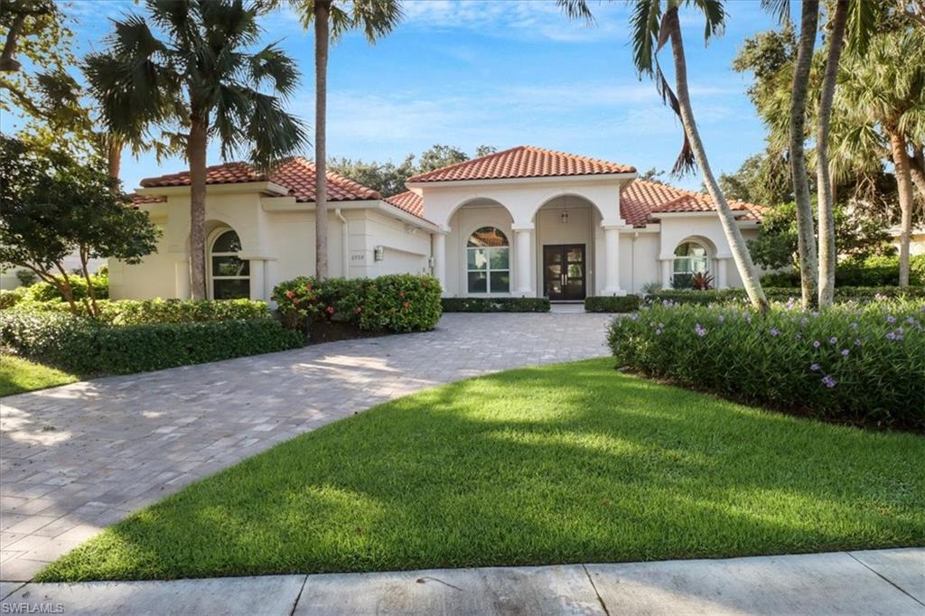Welcome to your very own luxury oasis! This home is located on one of Pelican Bay's most prestigious streets, Greentree Drive. A rarely available home site that offers stunning and private southern long lake views. Beautifully remastered with high vaulted ceilings throughout the main living areas. The desirable open concept floor plan features split bedrooms for privacy. Each living area flows seamlessly from one open area to the next. Including 4 bedrooms plus an enclosed den/office, 3.5 beautiful bathrooms, and 3,071 square feet of living space under air. The tall french front doors open to an elegant interior graced by wide plank blonde hardwood flooring, high ceilings, quartzite countertops, white shaker cabinetry, gourmet kitchen appliances, a wet bar with pass through window to the covered lanai, a stone wall fireplace, and the list goes on! Tasteful neutral tones throughout the home create a perfect, sophisticated ambiance. The inviting backyard features a screened-in sparkling pool, spa, and covered seating area. Enjoy peace of mind knowing this home is NOT in a flood zone and is fully protected with impact windows & doors throughout, and electric shutters along the back of the residence.