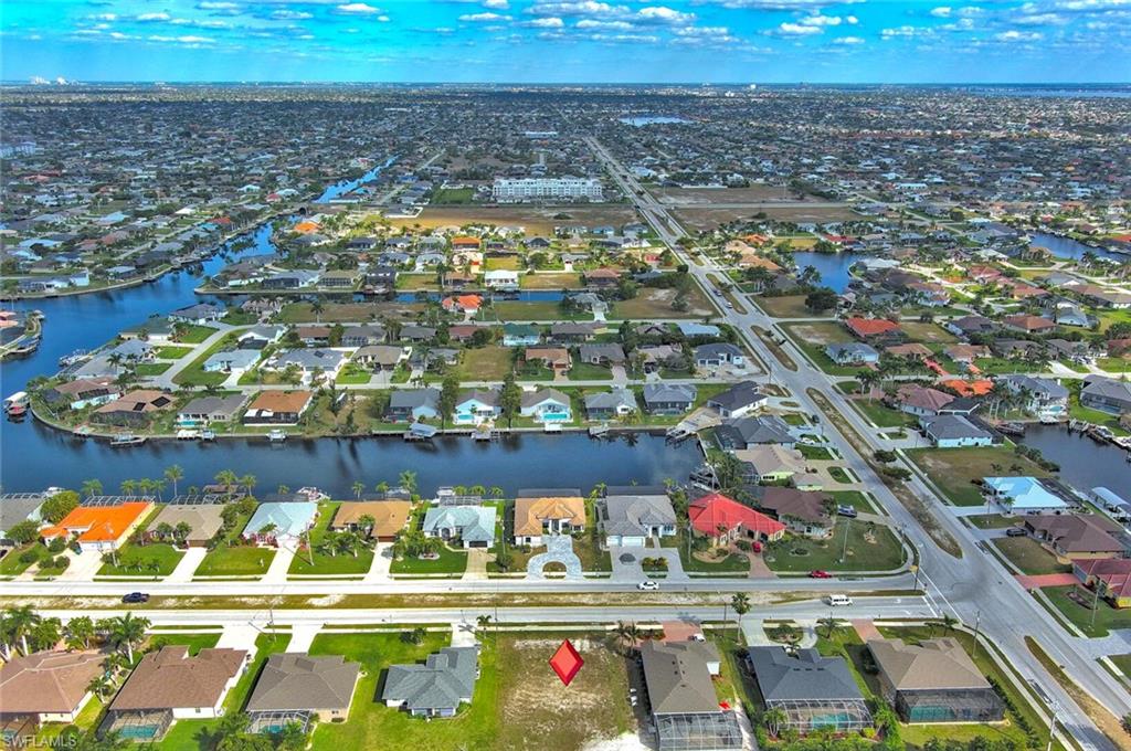 Build your dream home on this exceptional residential homesite located in one of Cape Coral’s desirable SW neighborhoods. This property offers the perfect setting for a custom home while providing easy access to everything Cape Coral and the surrounding area have to offer. A major advantage of this property is that city water and sewer are already in and fully paid, saving the new owner thousands of dollars in future utility assessments. Surrounded by beautiful homes and ongoing new construction, this lot is ideal for homeowners looking to build as well as builders and investors seeking a valuable opportunity in a thriving market. Conveniently located near shopping, restaurants, schools, parks, golf courses, medical facilities, and entertainment. Enjoy easy access to Downtown Cape Coral, Fort Myers, and the beautiful Gulf beaches. Whether you’re planning your forever home, a seasonal retreat, or an investment property, this property offers outstanding value and endless possibilities. Secure your piece of paradise today and start building the lifestyle you’ve been dreaming of. No HOA.