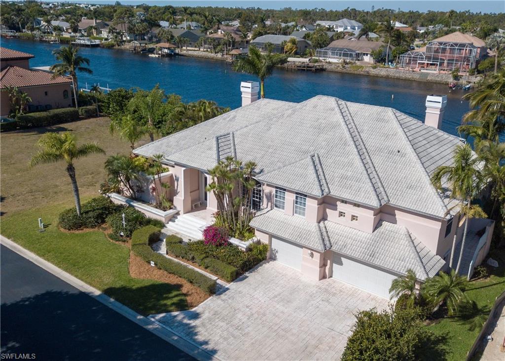Investors dream house for sale in the Harborage, a unique upscale gated community dominated by year-round, active, water-loving homeowners.  WHY INVEST?  B/C no matter where you are in this home you'll be able to view the breathtaking water views leading to the Gulf of Mexico.  PRICED UNDER MARKET this 4 bedroom, 3 bathroom estate home offers 3,443 sq. ft. under A/C and over 5,876 total sq. footage.  It's HUGE!  Homes around this home are selling for OVER A MILLION.  Since the home was built in 1994, you'll most likely want to update the flooring and color palette but you won't need any structural changes as the floor plan is very open.  This is no cookie cutter home with key features that include 2 wood burning fire places, in-home beauty salon, crown molding, tray & volume ceilings, recently upgraded kitchen with stainless steel appliances, granite counter tops, not to mention the huge over sized 3 car garage, built in grill next to the custom swimming pool overlooking both your fishing dock and boat dock.  The community has over 100 acres for water skiing, jet skiing, tubing or wake boarding, a community pool, tennis, playground and storage for RV, Boats, etc...Low HOA fees.