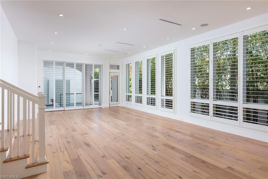 How refreshing — this coastal home has been completely refurbished to like-new condition and offers four bedrooms plus separate gathering room. This property will accommodate all your family and friends. Featuring a great room concept with an open kitchen and floor-to-ceiling windows that provide lots of light and blue skies. Ten-foot sliding glass doors out to the covered and screened-in lanai that’s equipped with a built-in gas grill/cooking area, quartz countertops and stainless hood. Overlooking the pool with a waterfall wall, lush landscaping and large spa, this private outdoor entertainment area will quickly become your favorite place to relax. Other details include wide plank washed oak flooring, quartz countertops, Sub-Zero, Wolf gas range top, oven and convection microwave and Bosch dishwasher. Spacious pantry right off the kitchen and the elevator provides access to top floor when you have your arms full. Just a short distance from 5th Avenue for morning coffee or dinner, and an easy walk to Naples pristine beaches. A nice lifestyle package and the perfect location for your Old Naples home.