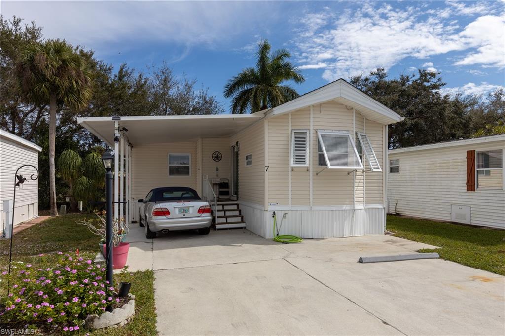 This cute little place offers something not found in this neighborhood very often.  It has a nice sized carport to protect your car from the beautiful Florida sunshine.  It has two nice sized bedrooms and one bathroom.   The second bedroom is currently being used as a sewing room.  The stackable washer and dryer are conveniently hidden in the second bedroom.  This cozy home is very comfortable with it's soft hues and sunlit windows making this a cheerful place to relax.  It also features a beautiful little deck where you can sit and enjoy the sunshine and the birds singing in the trees. The community of Imperial Wilderness is an active, gated, 55 plus community where you actually own the land.  You will never be bored here as there a many activities to keep you busy.