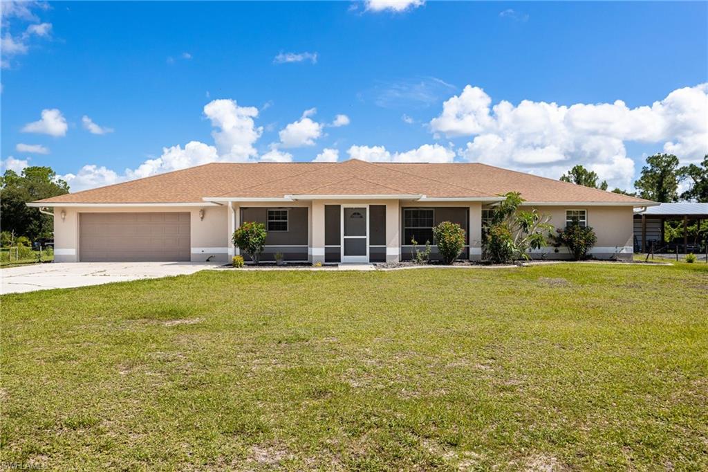 REDUCED! GEM OF A HOME! (AND SHOP!) The Floorplan Knows the Way to Comfort in this Manicured With Love Home located on 1.25 fenced acres in Lehigh Properties. Spacious Living with over 2700 square feet of “under air” is redefined here on PAVED 14th Place. Inside this well maintained home you will find a great floorplan with large rooms to easily accommodate your family.  Upgraded appliances enhance the perfectly planned kitchen and is a Recipe For Success: Efficient style plus inviting warmth! The large living room and spacious screened porch serves your large family well overlooking the massive front yard. A family room or game room beyond the dining room is a great place for entertaining. The oversized Utility room not only offers a washer and dryer but an extra refrigerator and extra range, hosting large dinner parties does not get any better! The large master suite combines plenty of closet space with built-ins and a spacious bathroom with a beautiful, large walk in shower along with double shower heads. Enjoy lower electric bills with 6" spray foam insulation as well as roll insulation along with insulated windows. Outdoors, you will find a 25' by 30' CBS shop offering 150 amp electric service and a roll up door, a Perfect spot for your toys or hobbies. If you have been searching for the perfect home on small acreage with a shop, conveniently located close to Lee County you owe it to yourself to take a look at this Beautiful offering! Schedule today!