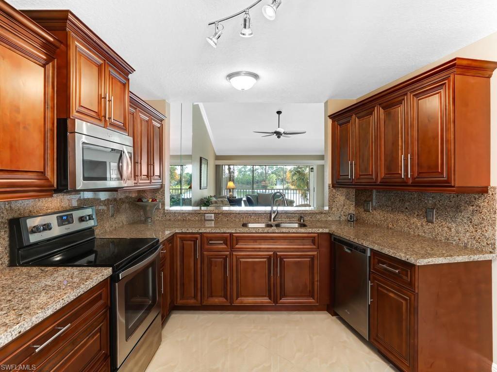 This beautifully remodeled from "top to bottom" home is move-in ready including furniture. (PLEASE CLICK ON VIRTUAL TOUR LINK AND WATCH THE VIDEO) Long Long lake view. Remodeled in 2015 this END UNIT has lots of natural light to show off the beautiful bright 18" diagonal tile floors throughout. The tiles are a beautiful cream and so shinny it feels like you are walking on water. Three bedrooms and 2 bathrooms provides all the space you need for the whole family.  Master has a private bath totally remodeled with granite and dual sinks, walk in shower totally remodeled and huge walk-in closet. Kitchen is eat-in and has been totally remodeled with granite, including granite backsplash and Whirlpool appliances in 2015. The kitchen breakfast bar opens into the living and formal dining space. Your Lanai provides all the comfort you need to enjoy the beautiful lake view and water feature.  Amenities includes a Community pool, Tennis courts, Bocce, Pickleball plus lots of events.  Easy access to down town 5th Ave and !-75 for trips to Miami or the RSW airport.  Seriously….this may be the best remodel you will ever see in Sapphire Lakes. Very active community LOW LOW HOA FEES. Will go fast.