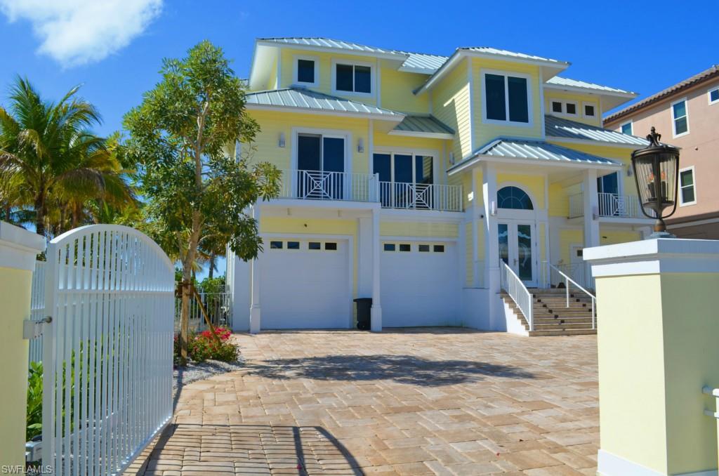 Rarely do you find the perfect home, until now. This 2014 custom built home has everything you could imagine, including a separate 2 bedroom guest cottage. Designed to capture views of the Gulf of Mexico from every room. Features include walnut hardwood floors brought in from Virginia, Lutron package for lighting, blinds & security system and showcasing a glass elevator lined with granite. This dream kitchen is perfection with Wolf Stainless appliances including a 6 burner gas cook top, glass door refrigerator, steamer, beverage cooler & wine cooler. Everyone can gather around your 13 by 5  foot island with walnut top. Marble counter tops surround the extensive line of cabinetry. The Master Suite is an Oasis; it's the whole 2nd floor! Suite offers Sauna, Steam Shower with double heads, fitness area, walk-in closets, office area, beverage center and large private balcony looking out to the Gulf waters . The ground floor level offers a spacious travertine tiled deck with pool looking out onto the white sandy beach. There are also 2 other bedrooms & 3 full baths in the main home. The 2 bed/1 bath cottage has also been beautifully updated throughout.