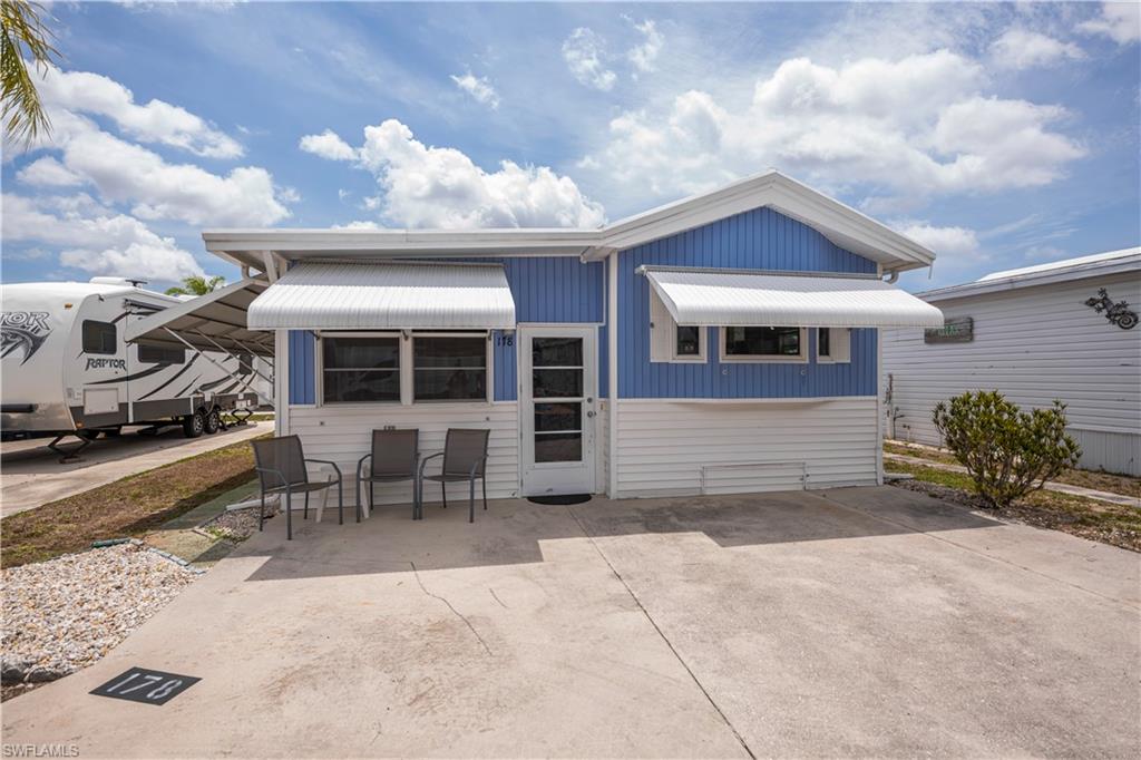 !! Just Reduced!!  Located in desirable Fountain View RV Resort, a well-established 55+ community where you OWN THE LAND, this beautifully maintained turnkey-furnished 1-bedroom, 2-bath home offers approximately 738 sq. ft. of comfortable living space. The spacious kitchen features an island, abundant built-in cabinetry, and opens to the living and dining areas, creating an inviting layout for everyday living and entertaining. Decorative mirrors add character and charm throughout the home, while the in-residence laundry provides added convenience. Enjoy relaxing outdoors on the rear covered patio, and appreciate the added protection and shade provided by the clamshell awning shutters, which can also be deployed when weather threatens. Recent updates include a NEW A/C system in 2025 and a newly installed 100-amp electrical panel with double-pole breakers and new circuit to a sub-panel. Residents of Fountain View RV Resort enjoy an active lifestyle with amenities including a clubhouse, community pool and spa/hot tub, bocce, shuffleboard, tennis, volleyball, basketball, and optional RV and boat storage. Conveniently located just minutes from downtown Fort Myers, shopping, dining, medical facilities, golf courses, and area beaches. Low HOA dues of $264.50/month include lawn and land maintenance, on-site management, recreational facilities, and a wide range of amenities designed for active adult living.