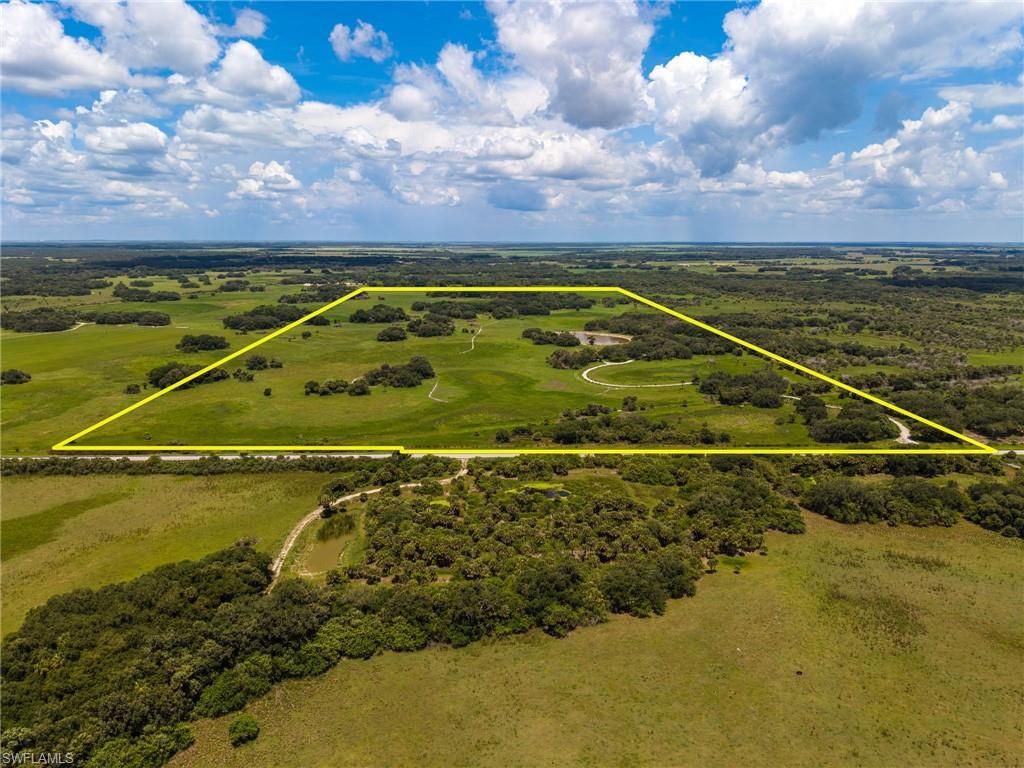 150± Acres of Prime South Florida Agricultural & Recreational Land! Rarely does a property of this size, quality, and location become available in one of South Florida's most desirable agricultural and recreational corridors. This exceptional 150± acre tract in southern Hendry County offers a unique combination of productive agricultural land, outstanding wildlife habitat, privacy, and long-term investment potential. Located on paved County Road 833 with secure gated access, the property is fully fenced and currently supports an active cattle lease. A newly improved internal driveway winds through the property, offering easy access while showcasing the natural beauty found throughout the acreage. The land is predominantly upland and free of any conservation easements, providing maximum flexibility for future ownership and land-use opportunities. Mature native oak hammocks are scattered throughout the property, creating breathtaking scenery and ideal habitat for the area's abundant wildlife. Outdoorsmen and nature enthusiasts will appreciate the exceptional wildlife presence, including Osceola wild turkey, white-tailed deer, and numerous other native Florida species. Strategically situated within one of Southwest Florida's most significant ecological and agricultural regions, the property lies approximately 30 miles north of Big Cypress National Preserve, approximately 5 miles east of the Okaloacoochee Slough Wildlife Management Area, and approximately 30 miles southwest of Lake Okeechobee. The surrounding landscape consists primarily of large agricultural holdings and extensive state-owned conservation lands, helping preserve the area's rural character and open-space views. Despite its remarkable privacy and seclusion, the property remains highly accessible. Naples and Fort Myers are both within approximately a 45-minute drive, allowing convenient access to Gulf Coast amenities while maintaining the tranquility of a true rural retreat. For buyers seeking expanded acreage, an additional 445± acre adjoining property is currently being offered separately by a neighboring owner, presenting a rare opportunity to assemble nearly 600 contiguous acres. Whether your vision includes cattle operations, a private hunting retreat, recreational ranch ownership, or long-term land investment, this remarkable 150± acre property offers a combination of location, habitat, accessibility, and land-use freedom that is becoming increasingly difficult to find.