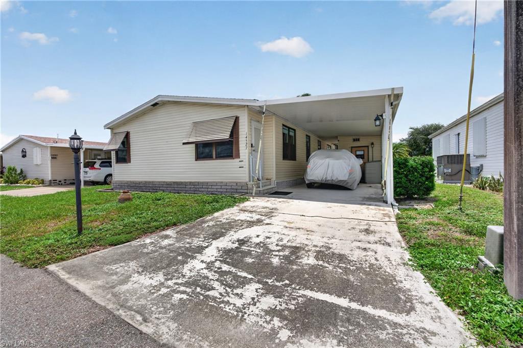 Welcome to 14527 Paul Revere Loop, where value, space, and lifestyle come together in Old Bridge Village, a resident-owned 55+ cooperative along the Caloosahatchee River. This 2-bedroom, 2-bath home with a den offers 1,260 square feet, a split-bedroom layout, spacious living and dining areas, an oversized owner’s suite, indoor laundry, a bright sunroom, patio, attached carport, and workshop/storage space.

What makes this home stand out is the way it lives. The den and sunroom provide extra flexible space for reading, hobbies, guests, or a home office, while the kitchen offers generous cabinet and counter space that is rarely found at this price point. Important updates include a 4.5-ton Trane A/C installed in 2021, gutters and downspouts in 2022, and a newer roof in 2022.

Old Bridge Village offers an incredible waterfront lifestyle with an 81-slip marina, direct access to the Caloosahatchee River, a brand-new pool and spa overlooking the marina, a riverfront park with a pier, boat ramp, clubhouse, pickleball, tennis, bocce, shuffleboard, fitness room, dog park, fishing pier, and more. This is more than a home. It is a place to settle in, get involved, and enjoy the best of the Florida 55+ lifestyle. Cash only. Pets not allowed. Buyer approval required.