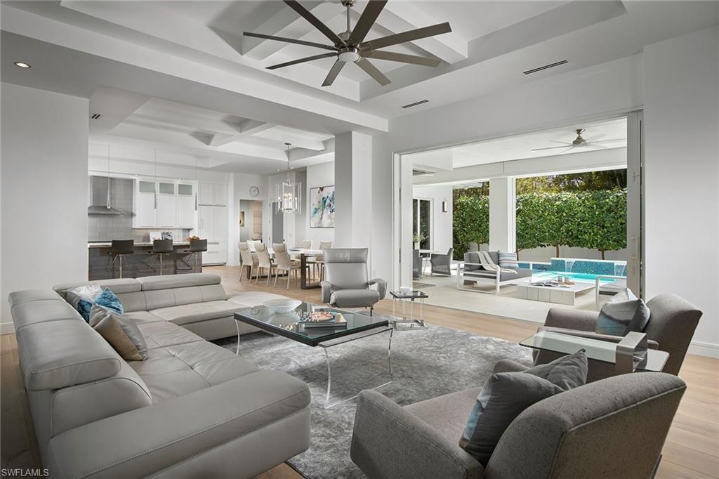 Ideally located in the heart of Olde Naples with close proximity to the beach, shops and dining, this coastal modern design has it all. Large banks of glass frame the home providing an abundance of natural light which fills the space. Warm white oak floors set the neutral tone while the custom white shaker cabinetry, rich wood tone center island and organic color stone materials give a modern flair. The first floor sprawls and provides a well laid out great room with access to the pool area and patio while also providing a private master suite with western views of the spa and pool waterfalls. With three additional bedrooms, loft space that acts like a den and covered patio with electric screens, this is the perfect floorplan for nearly every home lifestyle. Spend your days at the beach and nights on the expansive upstairs patio admiring the stars. Either way, this home is paradise found.