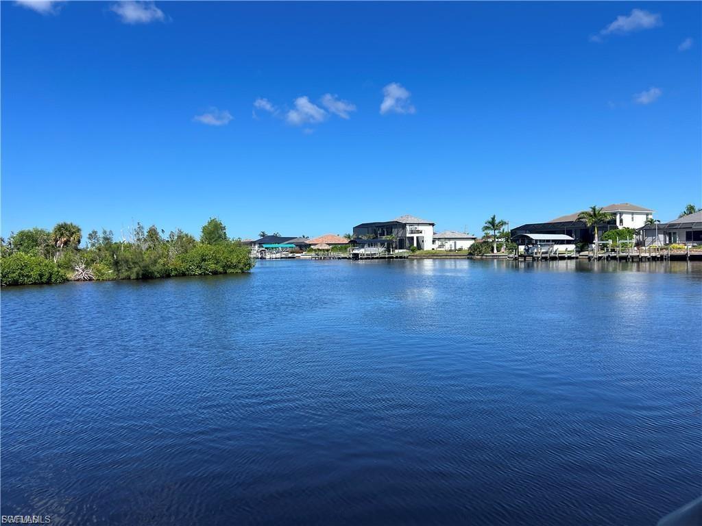 One of the best water views in the NW area of Cape Coral sitting on the spreader canal with over 200ft wide water view of protected mangroves for a great view and western sun sets.This lot sits right on the edge of a large intersecting canal for superb view.The lot is already sea walled and has a large boat dock and lift 13,000lb all trex deck for easy maintenance,approx 840ft of decking,set up for a tiki hut at a cost of almost $60,000. The only thing missing is a house, if looking for a builder we can help with that too,close to the upcoming 7 islands development, great for access to the back bays for fishing I know as I fish them or kayaking.Lots of new construction in this area or already built on.This lot is slightly deeper than a standard lot, and lots like this on the spreader with this view are extremely hard to come by.....\