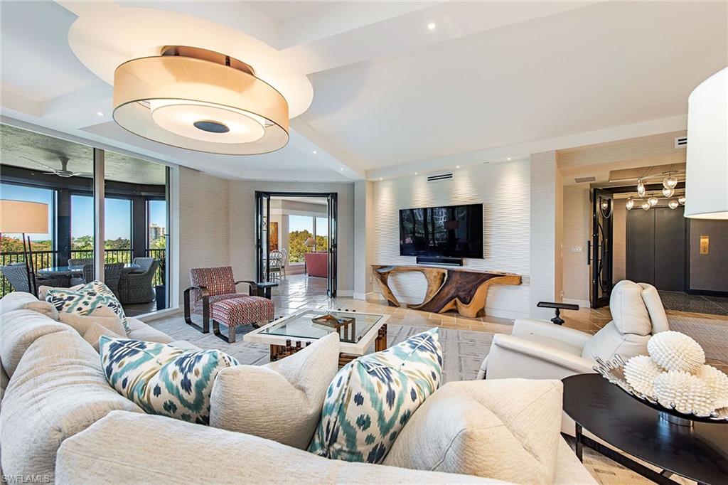 Welcome home to this absolutely stunning, renovated 4th-floor residence in the highly sought-after Trieste at Bay Colony. The secured elevator opens directly into this residence, providing 4,160 square feet of luxurious living, four bedrooms, four-and-a-half baths, neutral marble floors in all common areas, a gorgeous chef's kitchen featuring Gaggenau appliances, Snaidero cabinetry, waterfall countertop, electric sunshades and storm protection, 9'4" ceilings and two covered secured parking spaces. The interior flows effortlessly to two separate lanais where sunrises and sunsets can be enjoyed. The newly updated building features two guest suites, fitness center, theater, social room, board room and a resort-style pool and spa.