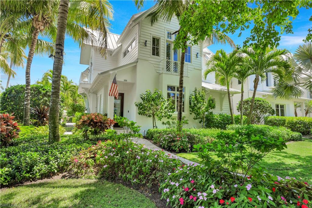 FLORIDA DESIGN MAGAZINE devoted 6 pages to this ultra luxury FURNISHED home in the heart of the walking district of Old Naples, on an unusually large 66' WIDE LOT and Extremely Well-Priced! Custom Designed Furnishings, Chandeliers, Chic Wallpapers and Finishes set this home apart with the ULTIMATE in design and quality! The light filled great room boasts a dramatic chandelier with 20’ floor-to-ceiling windows and provides abundant seating for watching the game or entertaining open to the lanai.  The Outdoor Living is simply exquisite and offers every convenience from sunkissed loungers, grilling kitchen, dedicated pool bath, charming fireplace seating, blue tiled waterfall wall, floral landscapes and a lovely view from all the main rooms.  Back inside, the kitchen accomodates "family cheffery"with top appliances, long counters of quartz covered high end Ruffino cabinetry and a view of the peaceful 6th Street canopy. The thoughtfully conceived first floor finishes with a powder bath, the primary bedroom, a glass encased sitting room, and a large spa bath.  Upstairs, the interior spaces transition harmoniously with spectacular den, 2 bedrooms en suite, and a charming surprise outdoor porch overlooking the pool! But that is not all!  There is a GUEST HOUSE with living room, kitchenette, bedroom, bath and two entries from the upstairs porch or outside staircase, perfect for total guest privacy!  Ideally situated on a corner lot, residents enjoy abundant green space and significant open-air entertaining areas.  Exceptionally well-located, one might take a stroll for breakfast, plan a beach or tennis afternoon, then stop by shops and art galleries on your way to fine or casual dining. Old Naples offers World Class Shops and Dining amidst the most charming beach town in the country!!  See Video link above.