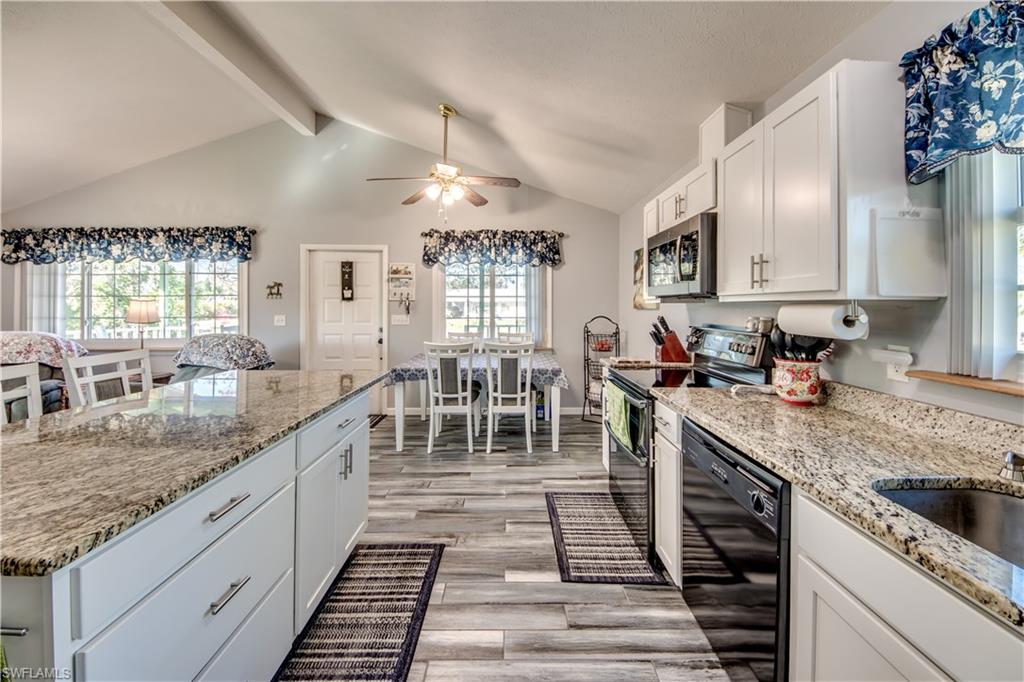 Darling updated low stilt home in the heart of Pine Island Center. Step in from the spacious front porch into an open kitchen with gorgeous white cabinets, granite countertops, double oven and the very popular black slate appliances. Enjoy sitting around the kitchen island open to the family room with high vaulted ceilings and newer carpet. The master suite has brand new carpet and a beautiful updated bathroom. Step out from the master bedroom into your own private screened patio and nice sized open deck. The roof was replaced in 2021, new HVAC in 2022, and the windows on the front of the house are hurricane impact. There is a large 12X24 storage shed with electricity for all your extra stuff. If you have a camper, there is a 50 AMP braker off the back of the house to plug right in to.  The home is located within walking distance of the library, community pool, parks, fire department, shopping and just 10 minutes to multiple public boat launches.  Make this your Island vacation home, primary home, or an incredible investment property, as there are no rental restrictions. Fall in love with this property and make it yours today!