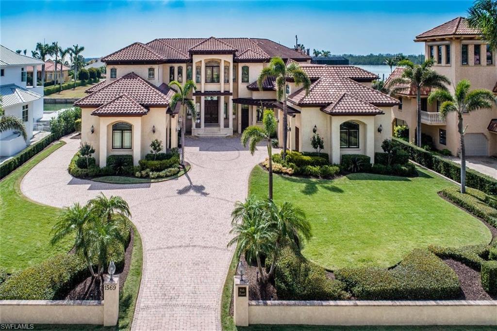 Villa Vineti -Enjoy watching the sun paint glorious colors on the horizon as it dips into the Gulf of Mexico at sunset from the over sized lanai or multiple balconies of this elegant Estate Area home. The views are phenomenal! Sunny southern exposure provides plenty of sunshine on the immense outdoor seating area with pool and spa. Step into the grand foyer and experience the soaring ceiling with designer mill work, Venetian plaster and even a grand piano. This well-appointed home features 4 bedrooms, an office, 2 dens, an incredible kitchen with a Butler’s Pantry, formal living room, formal dining room, breakfast room, theater room, family room, game room, informal dining, 4 full/ 2 half baths, and a 4 car garage (brand new central a/c unit in 2 of the bays!) What a boater’s dream location - 125’ on the seawall with a brand new sundeck & dock with a 13,000 lb. gear driven lift. 48 KW generator installed in 2018. One of the bedrooms in this amazing estate home is actually a guest/maid apartment complete with its own kitchen and laundry. The entrance to these quarters can be by way of a private exterior entrance and is optionally secured from the main residence if desired.