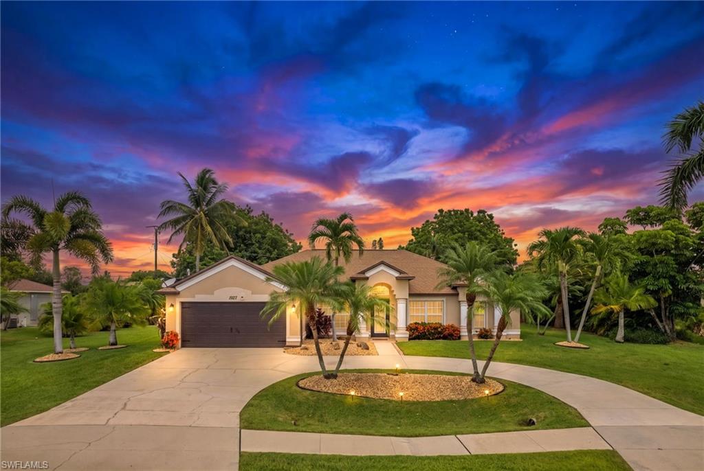 Welcome to your Dream home in Cape Coral! 3 LOT SITE!!! This stunning single family home boasts 3 bedrooms, 2 bathrooms, and a 2 car garage, perfect for a growing family or those who love to entertain. This Home truly is one to see. The in-ground pool with spa is the perfect place to relax and unwind after a long day, your outdoor living area offers an under truss lanai area the FULL length of the home! (This is very rare) while the inside of the home offers stainless steel appliances in the kitchen make cooking a breeze. The beautiful plank tile flooring throughout the home is not only stylish but also easy to clean. The master bathroom has been completely updated, adding a touch of luxury to your daily routine. New Roof 2022, Hot Water Heater, 2022. Outside, the 3 lot site offers plenty of space for outdoor activities, with a circular drive for convenience. The large yard is filled with palm trees and fruit trees, creating a tropical oasis right in your backyard. Located within walking distance to Ida Baker High School and Gulf Elementary School, this home is perfect for families with children. And with , shopping, restaurants, nightlife, and medical facilities just minutes away, you'll have everything you need right at your fingertips. Don't miss out on this opportunity to own a big, beautiful home in a prime location!