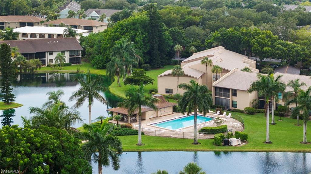 One or more photo(s) has been virtually staged, AI generated or rendered.  Fantastic North Naples location!!  This 2 bedroom, 2 bath condo is located in Cypress Gardens, a 55+ Community which is conventionally located within minutes of the I-75 Interchange and N Tamiami Trail. Walk to SAM’s Club, many other major retail centers and restaurants.  Located on the 2nd floor, this property faces west and overlooks a peaceful setting consisting of lush landscaping, mature trees, ponds and manicured grounds. Over 1200 sq ft of living space. Ceramic tiled entry. Large living room and dining area. In unit laundry hook up. Plenty of cabinet and counter space in the kitchen. The generous sized master bedroom suite has a walk-in closet and a private full bath complete with a double sink vanity and ceramic finishes.  Spend your time relaxing on this HUGE lanai area enjoying those Gulf Coast sunsets. Other great amenities include a community pool right outside your back door. A 1 car detached carport. Newer HVAC and water heater (replaced in 2025). This is a great opportunity to call Naples your home!