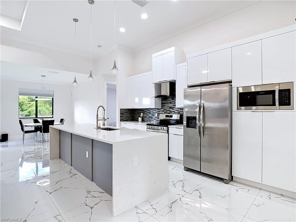 Discover your next chapter in this bright, move-in ready home built in 2025 with phenomenal walkability to shopping, and easy access to Lee Blvd and SR-82 for a smooth Fort Myers commute. Step inside this large single-family home with 3 Bedrooms, 2 Bathrooms + a Bright Den surrounded by an open-concept living area with plentiful natural light and a seamless flow for everyday living and entertaining. The kitchen anchors the space with stunning modern, European cabinetry and a waterfall, kitchen island covered in luxury quartz, while the split-bedroom design offers privacy for the exceptional primary suite with 2 walk-in closets with custom built-in cabinetry. The 2-car garage is light and bright with epoxy flooring and there's plenty of overflow parking in the beautiful paver driveway. The large screened-in lanai boasts a summer kitchen for entertainment. Outside, enjoy a generous FULLY FENCED yard with room to play, garden, or add a pool—perfect for sunny Florida afternoons. This home delivers comfort and convenience at a great value and checks all the boxes!