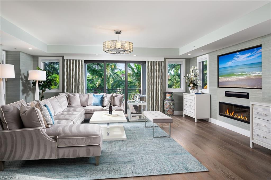 Esmeralda on Eighth offers a beautiful blend of luxury and tropical charm, ideal for those seeking a sophisticated yet relaxed lifestyle in Old Naples. The one-level floor plan offers a spacious feel, with upgrades including a built-in fireplace, wide-plank oak flooring and window treatments throughout. Crisp white kitchen offers abundant natural light, premium Thermador appliances, quartz countertops and large breakfast bar. Designer furnished and features like a coded elevator, a roomy two-car garage, and private pool and courtyard area, help strike a balance between boutique appeal and modern convenience.