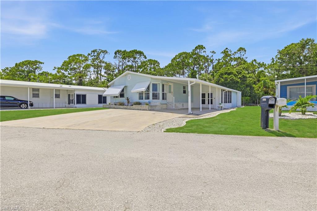 Beautiful 1994 3-bed, 2-bath home waiting for you in sunny Florida! The attractive kitchen has stainless appliances, beautiful laminate flooring, great counter space, laundry area, and a sweet breakfast nook. The spacious main living room with vaulted ceilings is super nice and perfect for entertaining. You'll find remote controlled lighting/fans throughout, and the upscale vertical blinds in every room operate with ease. You'll fall in love with the primary en suite with its mirrored spacious closet, bay windows, and pretty bathroom with double sinks. The two additional bedrooms offer your guests a bright, comfortable place to stay. The side lanai has double doors that will house your golf cart (included), and it's connected to the workshop/storage area which has a utility sink and a toilet! There is a nice storage shed behind the home as well.  Upgrades include shingle roof in 2024, outdoor electrical box, 2019 repipe, 2018 A/C unit, and transferable termite control contract. Forest Park is a friendly community with lots of activities and amenities. You own the land and pay a low  $122/month HOA fee. Forest Park is in a great location with easy access to main roadways, shopping, restaurants and lively downtown Fort Myers. Come and enjoy the Florida lifestyle!