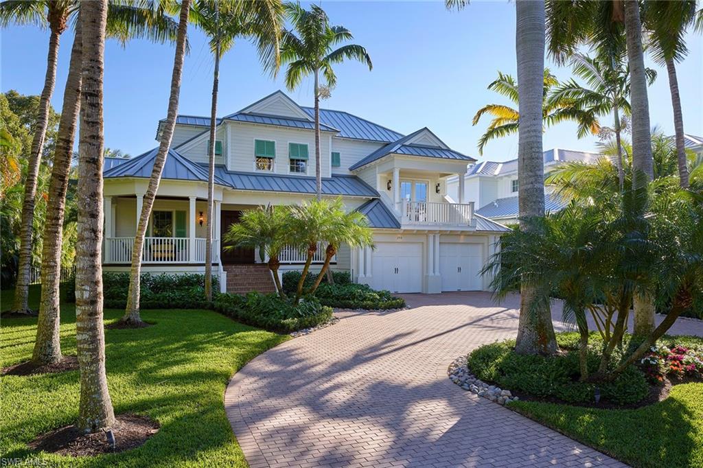 Ideally located just a short stroll to 3rd St S as well as the sugary sand of Naples Beach, this Old Florida gem has everything to offer. Recently renovated by BCB and finely detailed by Jett Thompson, the coastal interior design will have you relaxing in no time. Boasting soaring ceilings and luxurious finishes throughout such as Taj Mahal Quartzite countertops surrounding the custom inset cabinetry and the finest Wolf and Sub-Zero kitchen appliances, chic shell stone flooring, new standing seam Galvalume roof, charming front porch and so much more.  With ideal southern exposure, enjoy basking in the sun by the pool and spa or time with friends and family in the expansive covered area complete with built in Evo Grill and outdoor shower, all seamlessly opening to the great room through pocketing Windoor sliders. Delight in the first-floor master suite with charming sitting area, lined with bay windows for natural light, providing a warm ambiance. Whether a full-time resident or seasonal visitor, this is your opportunity to walk right into the perfect Naples paradise.
