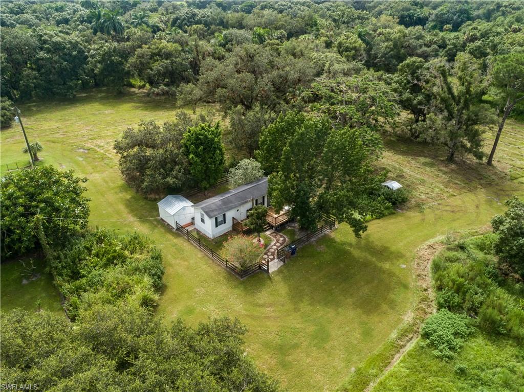 Buckingham beautiful old Florida country large 7-acre parcel filled with oak trees, palmettos, and pines. The property is located down a quiet remote tree lined road. A true country feel yet only minutes away from Fort Myers and US75. Build your dream estate home or enjoy the already quaint 1 bedroom/1 bath house with wooden deck ¼ acre fenced yard. Property also has concrete block building previously used as a kennel and could be used for workshop or man cave. Property is fenced for horses, goats, or a few cows. Title to property includes access to 50’ on the Orange River. Deeded Riverfront Property 3143260000017004C. Great place for Jon boats, kayak, or canoe.