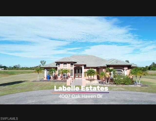 Welcome to Paradise at 4007 Oak Haven Drive

Nestled on an elevated 2-acre lot in the prestigious Oak Haven Estates of LaBelle, this 4-bedroom + Den, 3-bathroom, 3,052-square-foot fortress is the epitome of refined living. Built with exceptional craftsmanship, this well-constructed home boasts a solid roof and a robust design that has weathered all major hurricanes without flooding, leaks, or damage. It stands as a testament to durability and peace of mind, offering a secure haven for you and your loved ones.
Step inside and be greeted by the serene ambiance of a home designed for both luxury and comfort. The property’s exceptional insulation ensures that, even with its prime location near a major road, you’ll enjoy an oasis of tranquility where outside noise simply disappears.
The spacious interior flows effortlessly into the lush, expansive outdoor space, offering endless opportunities for relaxation, gardening, or entertaining. Families will delight in the close proximity to top-rated schools, shopping centers, and banks. And with Fort Myers just a short drive away, you’ll have access to vibrant city life while enjoying the quiet charm of one of LaBelle’s finest neighborhoods.
Homes on Oak Haven Drive are newly built and surrounded by an active, friendly community. This particular home stands apart as a private retreat—your very own slice of paradise.
Whether you're raising a family, seeking a peaceful escape, or looking for a solid, storm-tested property, this home has it all. Don’t miss the opportunity to own a home where luxury, durability, and serenity come together in perfect harmony. This is more than a house; this is your forever home.
