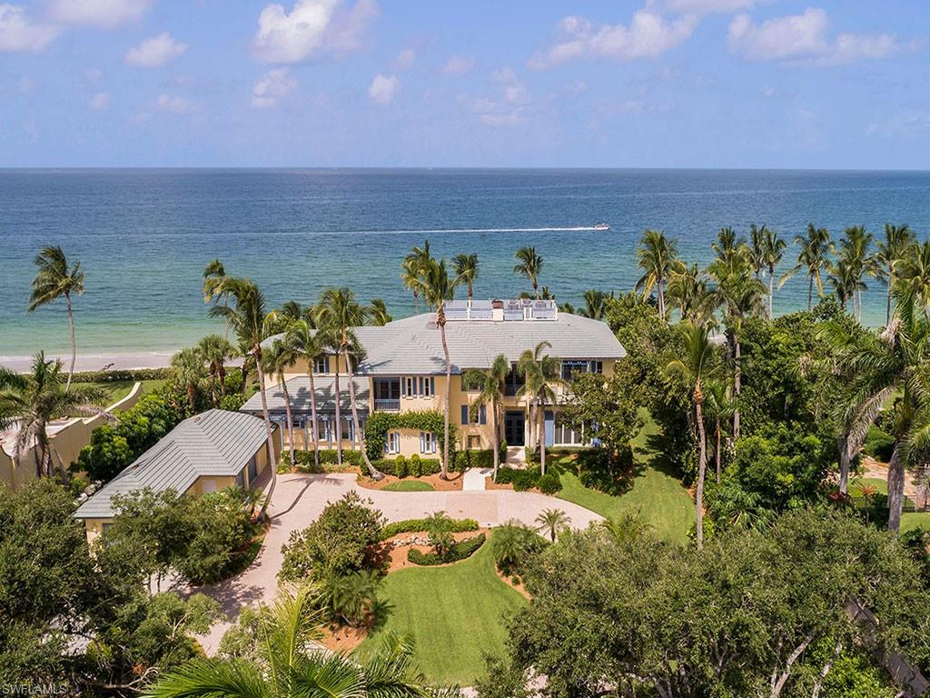 H.13538 - Beyond the gated entry, sits this stately and elegant home overlooking the Gulf of Mexico, boasting over 7000 Sq Ft of luxurious living area. Mature lush landscaping imparts a sense of tropical solitude and privacy in this beachfront setting with 166 feet of Gulf beach frontage. This exquisite beachfront residence was designed by esteemed architect Andrea Clark Brown and built and finished to the most exacting standards by A. Vernon Allen Builders with an elegant and refined quality all its own. An impeccable home, in an incomparable beachfront location, in the prestigious Port Royal neighborhood.