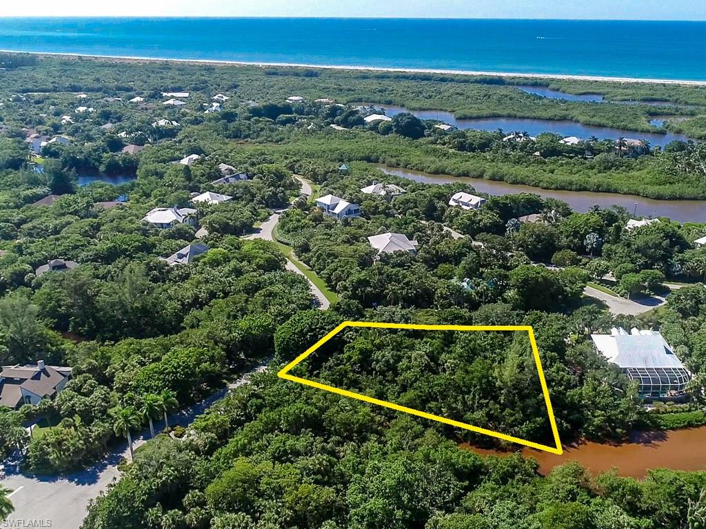 Incredible Value! Such a deal for someone wanting to live their island dream!  This property was purchased for 280K 5 years ago, the Sellers are very motivated!  Design your dream home from the ground up with every detail, just how you imagined it. But the real magic?? Morning laps just steps away in the sparkling community pool (hello, low-impact cardio and instant refresh). Afternoon rallies on the tennis courts (your built-in stress relief + social time). Evening strolls to your private community beach access (no crowds, no parking stress, just sand, serenity, and sunset skies). Now you find out that you can start this dream...at a dream price! The Paradise Pointe floor plan image could be a good fit for this lot, the home would need to be elevated for additional details contact Sanibel Homes.