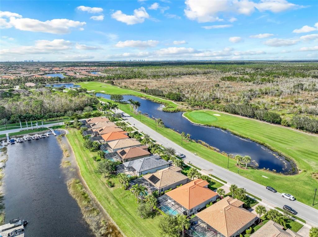 SOUTHERN EXPOSURE/NAVIGABLE LAKE ACCESS PLUS GOLF & WATER VIEWS FROM THE FRONT & REAR OF THIS HOME! LIVE A VACATION LIFESTYLE IN THE QUARRY! This 3 bedroom 2 bath home is in pristine condition. Enjoy the beautiful view of Stone Lake from your expansive lanai. The UPDATED KITCHEN features Counter Height Quartz Countertops and White Cabinets.  Fine appointments include Bamboo Wood Floors in main living area, Crown Molding throughout, Plantation Shutters, Upgraded Light Fixtures, Tray Ceiling in the Owners Suite, Newer Upgraded Carpeting (1 Year) in the Bedrooms plus more!! There is a Built in Queen Size Murphy Bed in the 3rd bedroom to use as a 3rd bedroom/Home Office. As an added protection there are Electric Shutters on the Lanai and the Front Door.  The Quarry is a gated lakefront community offering over 500 acres of lakes for boating, water skiing, paddle boarding, jet skiing, kayaking, and fishing.The Beach Club includes Tennis, Pickleball, Bocce Ball, a Tiki Bar, Restaurant, Pool-Side food/drink service, Fitness Center, and a full-time activities director. The Beach Club is undergoing an $18 million Expansion and Renovation Project which is expected to be completed mid 2023.