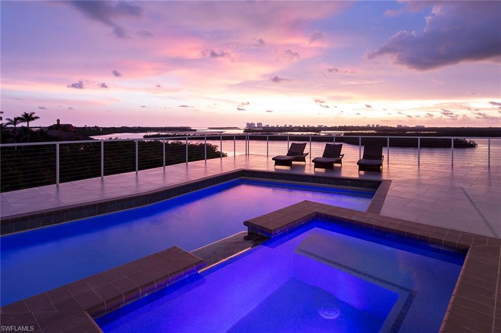 Welcome to this magnificent three-level luxury estate on nearly one-acre of natural beauty and preserve set against a stunning backdrop of bay, skyline and sunset views. This 2014-built, 6,500 air-conditioned five-bedroom, five-and-three-half-bath home combines modern construction/design, clean lines and muted tones while blending in the natural surroundings. The main living area/master and pool are located on the third level, with additional en-suites, second kitchen and billiard room on the second floor. The outdoor living is spectacular with multiple porches, decks and an incredible rooftop sundeck designed for relaxation, entertaining or to soak in one of the most amazing views found on Marco Island. The pool is located at least 30’+ on the third level. This unspoiled, tropical setting offers the privacy and serenity one can only hope for where water, sky and preserve envelope the property. Elevator services all levels and an oversized 3+ car garage with abundant storage. Located in the private, historical gated community that is Key Marco; offering assigned direct access boat docks, tennis, fitness and community center.