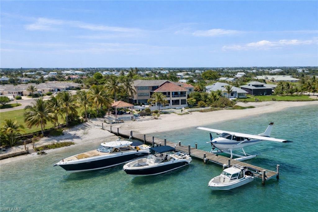 Not everyone can get here… and that’s exactly the point. Indiana Jones Adventure Meets Luxury Island Living | Rare Fly-In / Boat-In Captiva Estate. Set along the waters of Pine Island Sound with views to the Gulf of America, this extraordinary Upper Captiva property offers one of the most unique lifestyles in Southwest Florida. Located on approximately 1.16 acres, this private island retreat is accessible by boat or private aircraft via Salty Approach Airstrip (FL90), Upper Captiva’s private 1,800-foot grass runway. The property also includes a hangar below the home, making it ideal for aviation enthusiasts. FL90 is best suited for experienced pilots flying light aircraft designed for short-field and turf operations, including planes in the style of Cessna 150, 152, 172, 182, 206, Piper Cub, Super Cub, Aviat Husky, Maule, Kitfox, and similar STOL-capable aircraft. For seaplane owners, welcome home. The residence features 5 bedrooms, 5 bathrooms, and over 3,900 square feet designed to capture panoramic water views and sunsets. A private elevator services all four levels. Inside, the home offers spacious living and entertaining areas with marble, tile, and wood flooring throughout. The chef’s kitchen includes premium appliances, wine and beverage refrigeration, ice maker, and an open layout ideal for hosting. Outdoor living is exceptional, with expansive terraces and gathering spaces overlooking the water. A new Trex waterfront deck leads to a private composite dock with boat lift, ideal for a 40-foot Viking for serious fishing adventures, plus a fast boat such as a Nortech or Midnight Express for island-hopping and cruising. The dock may also accommodate a seaplane. Additional features include whole-house generator, hurricane impact windows and doors with shutters, outdoor kitchen, poolside cabana, exercise room, multiple entertaining spaces, and well water, septic, and propane gas service. A rare combination of privacy, adventure, and luxury waterfront living in one of Southwest Florida’s most exclusive island communities.  Created for those who crave privacy, adventure, and a true sense of escape, this estate offers a lifestyle few properties can match. Spend your mornings heading out by Viking for serious fishing, your afternoons cruising by fast boat to nearby islands, and your evenings enjoying panoramic sunsets over Pine Island Sound. With a hangar below the home, private dockage, expansive terraces, and resort-style outdoor living, every detail supports an effortless fly-in, boat-in island lifestyle. This is more than a residence. It is a gateway to one of the most extraordinary waterfront experiences in Southwest Florida. With exceptional access to Boca Grande’s renowned deep-water fishing right from your back door, this remarkable estate is designed for the buyer who expects the extraordinary. Complete with a private sauna and every luxury appointment. The 29'5" x 36'7" hangar-style garage offers substantial space for aircraft.