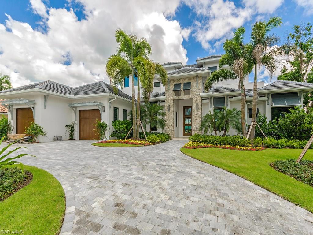 H.10018 TEC Construction and Development presents a stunning NEW waterfront home with easy gulf access. Enjoy this modern beauty and contemporary 2-story floor plan with high-end finishes and attention to every detail. Lush and inviting landscaping frame the welcome to a grand stone-laden entrance. Soaring ceiling heights in the foyer are flanked by a den on one side and intimate dining room on the opposite side. This gourmet kitchen flaunts show-stopping Italian-made Snaidero cabinetry in its sleek design, rich grain textures and concealed cabinet pulls. Select Bosch appliances, a Thermador wine-cooler and a single streamlined sink set in pristine Quartz counters complete the scene. Soft, beautiful flooring begins on the first floor with a wide-plank French oak, inspired by an Italian wood master and crafted in Belgium. Custom tile in the bathrooms add a clean finish. Three fireplaces warm the great room, lanai and second-floor balcony. Life outdoors begins on a multi-leveled Travertine lanai with an elongated pool fit for swimming laps alongside a spa with a cascading spillover. A new seawall and 17,000 lb. boat lift set the perfect scene for local boating and gulf access.