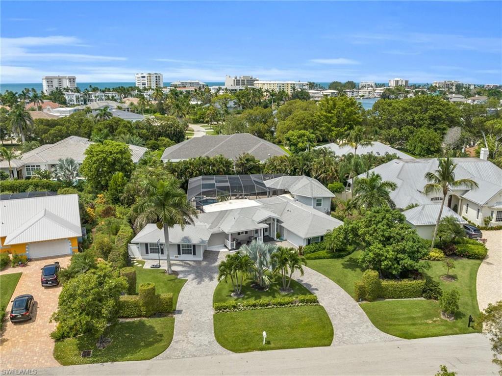 Welcome to a stunning oasis nestled in the heart of Naples' coveted Coquina Sands neighborhood. This single-family gem effortlessly blends luxurious living with the relaxed charm of coastal Florida, offering an unparalleled lifestyle just a short bike ride from the beach.

Completely updated in 2021 and 2022, this 4-bedroom-plus-den residence spans 2,488 square feet of elegant living space (3,209 total) and is designed for both comfort and style. Step inside to discover fresh flooring, a sleek modern kitchen, spa-inspired bathrooms, and thoughtfully curated furnishings that convey a sense of effortless sophistication. Sold turnkey, this home comes fully furnished—including bikes, two refrigerators, and even a brand-new outdoor grill—making your transition to paradise seamless.

Outdoors, the property truly shines. Picture yourself lounging by the expansive 38-foot resort-style pool, soaking up the sun on the elevated deck with stunning views, or unwinding in the screened-in lanai surrounded by lush, private landscaping. There's plenty of grassy space for pets or play, as well as ample room to customize your future dream home on this nearly half-acre lot.

Practical updates include Hardie Plank siding, two air-conditioning zones, and a newer pool heater and pump. And with no HOA dues, the freedom to enjoy your property your way is all yours.

Located just moments from the upcoming Four Seasons Resort, world-class shopping, vibrant dining options, and the charm of 5th Avenue, 1627 Murex Lane offers the perfect blend of privacy, convenience, and luxury. This is more than a home—it’s a lifestyle.