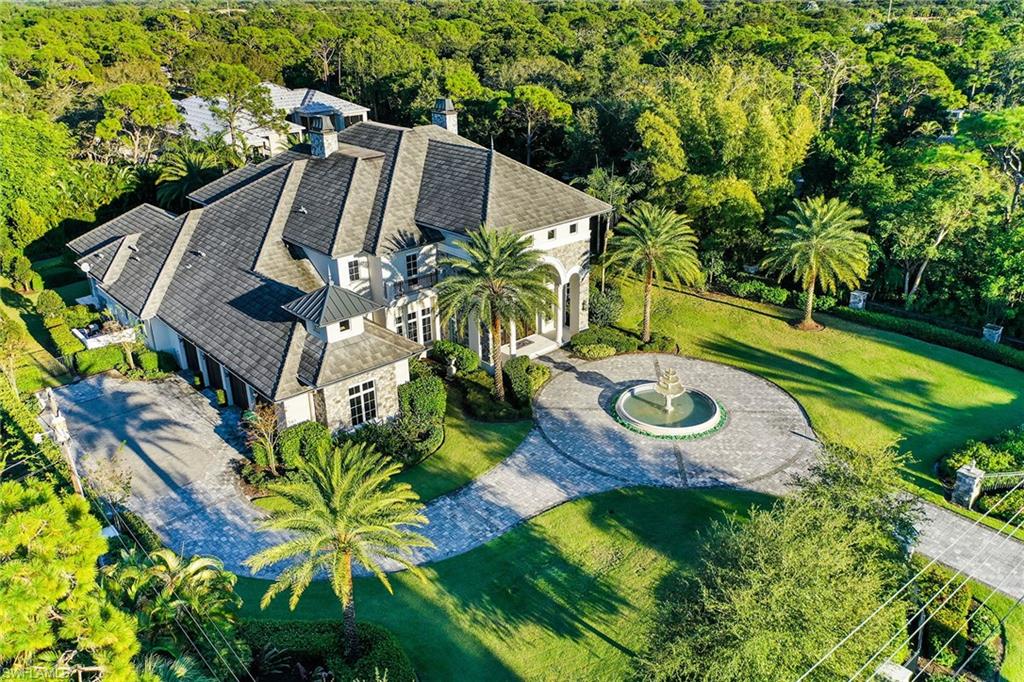 Impeccably designed and built with attention to every detail. This stunning home has a captivating entry with butterfly staircase, marble floors, 35-foot ceilings and dramatic 2-story windows that bring in an abundance of natural light. Perfect for entertaining with an open great room with gorgeous marble wet bar, custom cabinetry, wine coolers, refrigerator, and ice maker. Gourmet kitchen has Viking appliances, white cabinetry, large center island, and a dramatic brick-barreled rolled ceiling. The main level primary suite retreat has a sitting area, morning kitchen, gas fireplace, and screened lanai. There is a main-level en-suite guest bedroom. Two spacious en-suite bedrooms on the second floor along with a game room that opens up to a screened lanai that overlooks the resort-style private backyard with putting green, fire pit area, sparkling pool with spa and sun shelf. The custom outdoor living and dining oasis has a summer kitchen with pizza oven, refrigerator drawers, gas grill, and plenty of seating on the expansive island. 4-car garage with sauna, exercise room and ample storage. Highly desired Naples location just minutes to Vanderbilt Beach, Mercato and Waterside Shops.