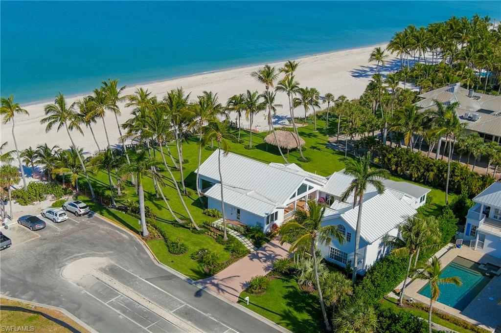 No damage to the house from hurricane Milton! Stunning Beachfront Property with 151 feet (.95 acres) of Beach frontage with views of the Naples Pier! Experience the pinnacle of seaside luxury at this exceptional estate located in distinguished Olde Naples, where direct access to the pristine Gulf of Mexico beach defines an elite living experience. This property, with a commanding presence and western exposure, offers awe-inspiring sunsets that paint the sky, visible from nearly every vantage point of this meticulous residence. Crafted with an uncompromising attention to detail, the estate unfolds over a sprawling single-story layout designed for the most discerning tastes. The expansive grounds are meticulously landscaped to ensure privacy while providing panoramic views of the Gulf’s turquoise waters. Inside, the residence features a strategically positioned dining area adjacent to a state-of-the-art kitchen. This space boasts picturesque windows that not only illuminate the interiors with natural light but also offer breathtaking ocean views, making every dining experience a scenic indulgence. Above the three-car garage lies a beautifully appointed guest suite, which doubles as a tranquil yoga fitness room with yoga walls and swings. This space is enhanced with a luxurious steam shower, offering a private retreat for relaxation and rejuvenation, all while enjoying elevated views of the coastal surroundings. There are also ocean kayaks and paddle boards for your enjoyment. This estate’s prime location in Olde Naples places it within close proximity to the iconic Naples Pier and the vibrant array of upscale shopping and dining options. The affluent lifestyle offered by this area is unparalleled, making it a coveted destination for those seeking exclusivity and convenience in a beachfront setting. 71 18th Ave S is more than just a home; it is a statement of luxury and an invitation to enjoy a life of opulence and serene beauty. With its direct beach access and sumptuous amenities, this estate is a rare jewel in Naples’ prestigious real estate market, crafted for the most prestigious buyers seeking a sanctuary of the highest caliber. Walking distance to famous 5th Ave and Third Street where you can enjoy the fine dining, boutique and antique stores, performing arts, car shows, art fairs right on 5th Ave, free concerts at Cambier Park, all of it just steps away.