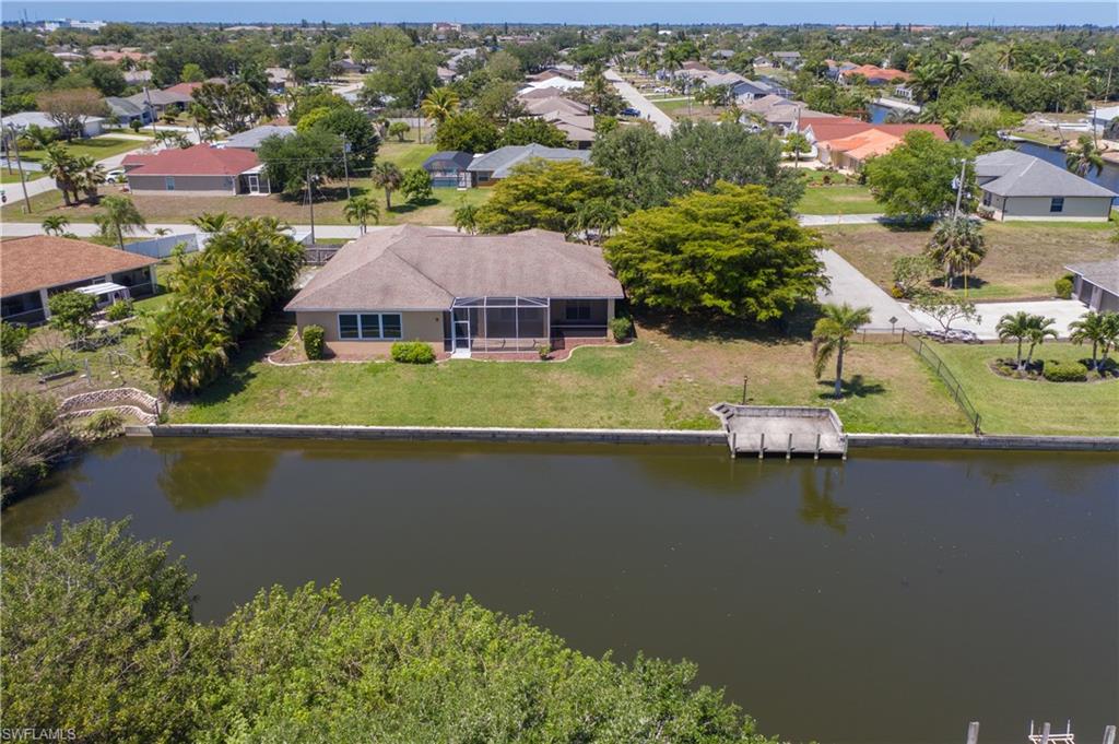 Spacious 4 Bedroom 3 Bath home located on an oversized 3 Lot Site Directly on a Fresh Waterfront Canal. 2 Master Bedrooms!  Expansive and Airy with Tall 10 Foot Ceilings!  Tile floors throughout!  New Hurricane Windows in 10/4/2021!  Large Kitchen with plenty of room for the gourmet cook!     Oversized 2 and half car garage.   Large Fenced in yard.  Over 150 Feet of Waterfront!
New complete AC System 2/5/2021.   City Water and Sewer all assessments paid.  Not in a Flood Zone!  Steps away from Paul Sandborn Park!  Easy quick Access to all types of Schools,  Churches,  Shopping and Dining!  This is the best value for a fresh waterfront home in the area and offers plenty of privacy!