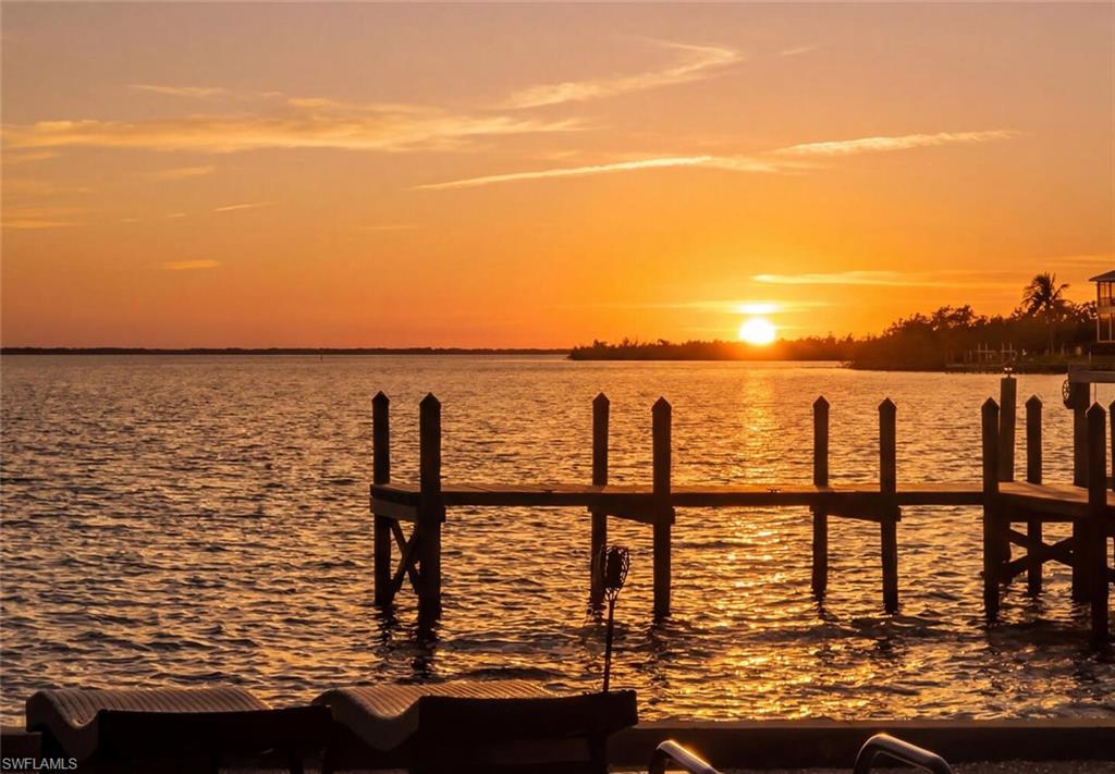 Unobstructed views of the bay. You, too, can wake up to this every day. “Sittin’ on the dock of the bay, wastin’ time…” It’s hard not to hear (Sittin' On) The Dock of the Bay as you go onto the expansive dock of this exceptional bayfront property. Quietly tucked on a half-acre along the shores of Pine Island Sound, this home offers unrestricted deepwater boating and direct Gulf access. The large private dock can accommodate substantial vessels, making it ideal for serious boaters and sunset cruisers alike, and ideal for casting a line and fishing from your backyard. Inside, the home offers three bedrooms, including two spacious primary en suites. Completely updated while preserving its timeless Old Florida charm, the residence features tropical décor, with furnishings negotiable (with exclusions). The open-concept great room seamlessly connects the living and dining areas and is anchored by a striking double-sided stone fireplace. Designed for effortless island living, both primary suites and the great room overlook the pool and sparkling bay, creating a seamless flow between indoor comfort and outdoor beauty. The half-acre homesite is fenced in the rear and ideally in the heart of Captiva Village. From here, you can easily stroll to nearby amenities, restaurants, the local grocery, Captiva Chapel by the Sea, the Captiva Civic Association and popular island resorts. Evoking the quiet simplicity of days gone by, this Old Florida-style retreat invites peaceful mornings on your dock, afternoons by the pool, fishing from the dock, and evening visits to the beach for shelling or sunset strolls along the gorgeous Gulf beaches. Whether you’re seeking the ultimate island escape or a smart investment, this property has recently operated successfully as an Airbnb, offering built-in revenue potential for the discerning buyer. An island gem.