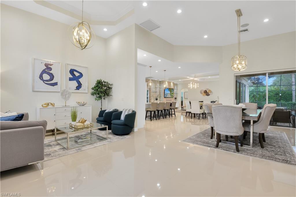 Enjoy the best of South Florida living in this highly desirable gated community located in the heart of Naples! This home offers a comfortable split bedroom floor plan w/ luxury features throughout, gourmet designed kitchen w/ white quartz countertops & high-end appliances, Sonos surround sound throughout, formal front sitting room, open lanai at front of home w/ view of lake, French door front entry, family room (w/ coffer ceiling, electric fireplace, & stone wall detail), contemporary light fixtures & fans, custom shelving systems in closets, volume ceilings & 8ft doors, beautiful tile flooring throughout, disappearing sliders in family room, and stunning outdoor living space w/ LED pool & accent lights, summer kitchen, spa & pool, and under truss sitting area. New hot water heater just installed last year. Delasol is gated with a guard 24/7 offering resort-style amenities-including community room w/ a library, tennis courts, amazing community pool & spa - all situated on 147 acres of lakes & nature preserves. Over half of Delasol's land is preserved for the natural landscape of Florida, creating a beautiful place to call home!