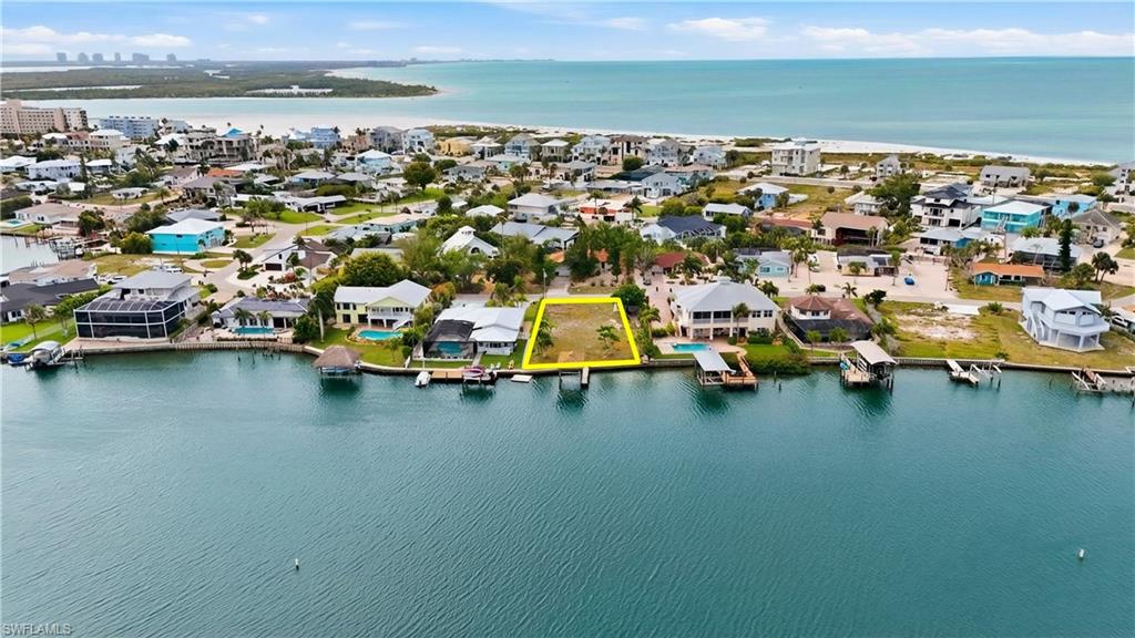 Discover a rare opportunity to be part of the exciting renaissance of Fort Myers Beach with this exceptional oversized waterfront lot in the coveted Laguna Shores community. Perfectly situated along the scenic lagoon, this property offers a tranquil setting with beautiful water views and direct, quick access to the Gulf, just 5 minutes to the open water—ideal for boating, kayaking, or simply embracing the coastal lifestyle.

Located on the quiet and private south end of the island, Laguna Shores is known for its peaceful atmosphere and hidden charm, making it a true retreat away from the crowds. Privacy is the most talked about feature of this property and you’re perfectly positioned to enjoy everything the area has to offer. Fort Myers Beach is experiencing a remarkable revitalization, with new development, refreshed amenities, and a renewed energy that’s bringing the community back better than ever—making this the perfect time to invest and build your dream home.

Convenience is key, and this location delivers. You’re just a short drive to Naples and Bonita Springs for upscale dining, shopping, and entertainment, and only minutes from Southwest Florida International Airport for easy travel. Nearby Santini Marina Plaza adds to the appeal with a variety of local shops, restaurants, and marina access right around the corner.

Whether you envision a luxurious waterfront estate, a seasonal getaway, or a smart investment in a rapidly rebounding coastal market, this property offers endless potential in one of Southwest Florida’s most promising locations. Come be part of the future of Fort Myers Beach while enjoying the timeless beauty of waterfront living today.
