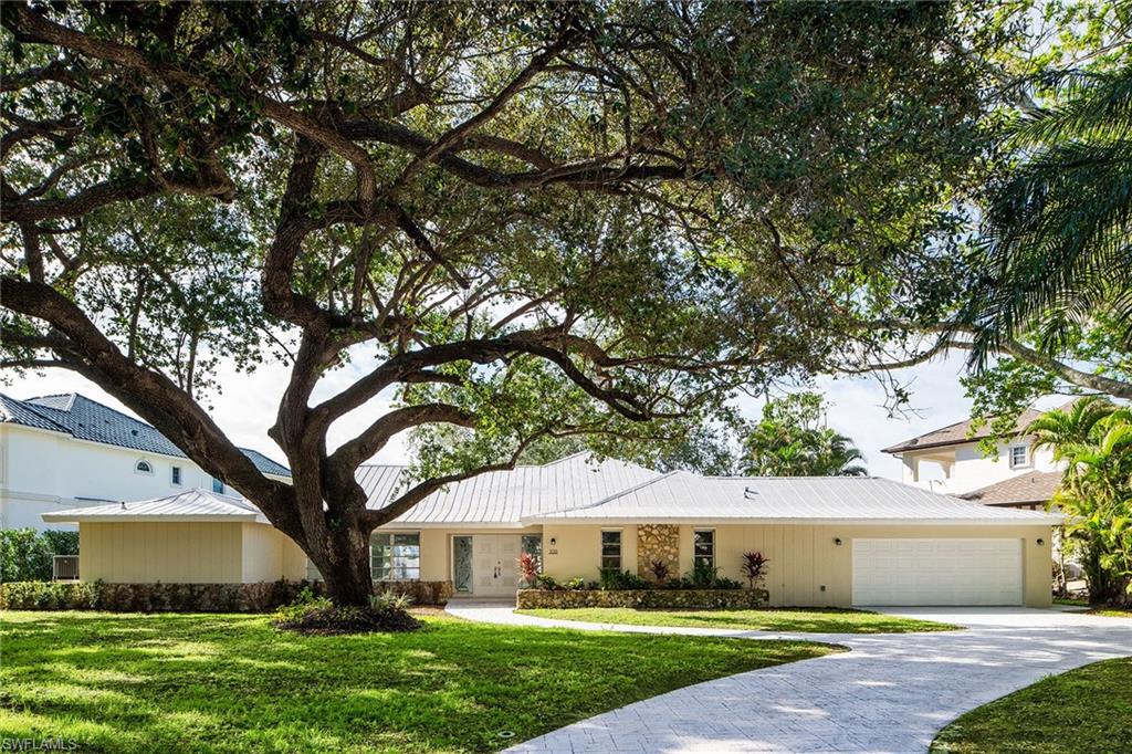 This is the optimum waterfront site for a sailor or power-boater who wants a sheltered mooring site with almost immediate access to the gulf. Doctor's Pass is five minutes from the dock. There are no bridges and adequate depth! The southwest exposure from the rear yard and dock provides stunning sunsets over the wide lagoon, and the soft prevailing sea-breezes keep the pool area comfortable year-round. The residence has been completely re-constructed over the last two years with a new roof, new partition walls, baseboards, cabinetry baths, appliances and HV/AC equipment, and is ready for owner decorating and occupancy or rental. The floor plan has split primary suites, a third guest bedroom and a large den or office. Surrounded by mature live oaks in one of Naples loveliest neighborhoods, it is offered at lot value and awaits your pleasure.