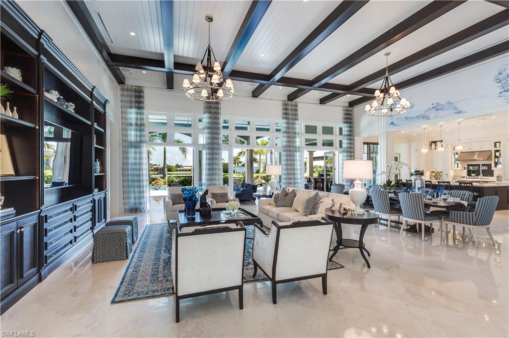 Gorgeous Golf Course and Lake Views! Perfectly situated on almost an acre of lushly landscaped grounds, this 4 BR+Den, 5.5BA. Designed by Stoft Cooney Architects - Interior Design & Furnishings by Pacifica Interior Design - Outstanding Construction by Diamond Custom Homes. Double entry doors open to foyer leading to a expansive Great Room with open & bright spaces. Adjacent to Large Living and Dining Areas Dining there are two Unique Wine Rooms enclosed with ½” tempered glass. Gourmet Kitchen offers Custom Cabinetry, granite counters, and the finest appliances. Details throughout include Extensive Mill Work, plantation shutters, custom built-in closets, designer fixtures, marble and wood flooring throughout + more. French doors open to a covered lanai with wood ceilings and retractable screens around living area with fireplace, dining and Outdoor Kitchen with wet bar which is equipped with the best of the best. Fabulous Oversized pool and separate spa with wet wall is flanked by fire bowls on pedestals. Crestron Home Automation/Lutron Lighting/Sonos Surrond Sound ++ (see feature sheet) Furnishings include all designer decorations & electronic systems including 10 flat screen TV's!